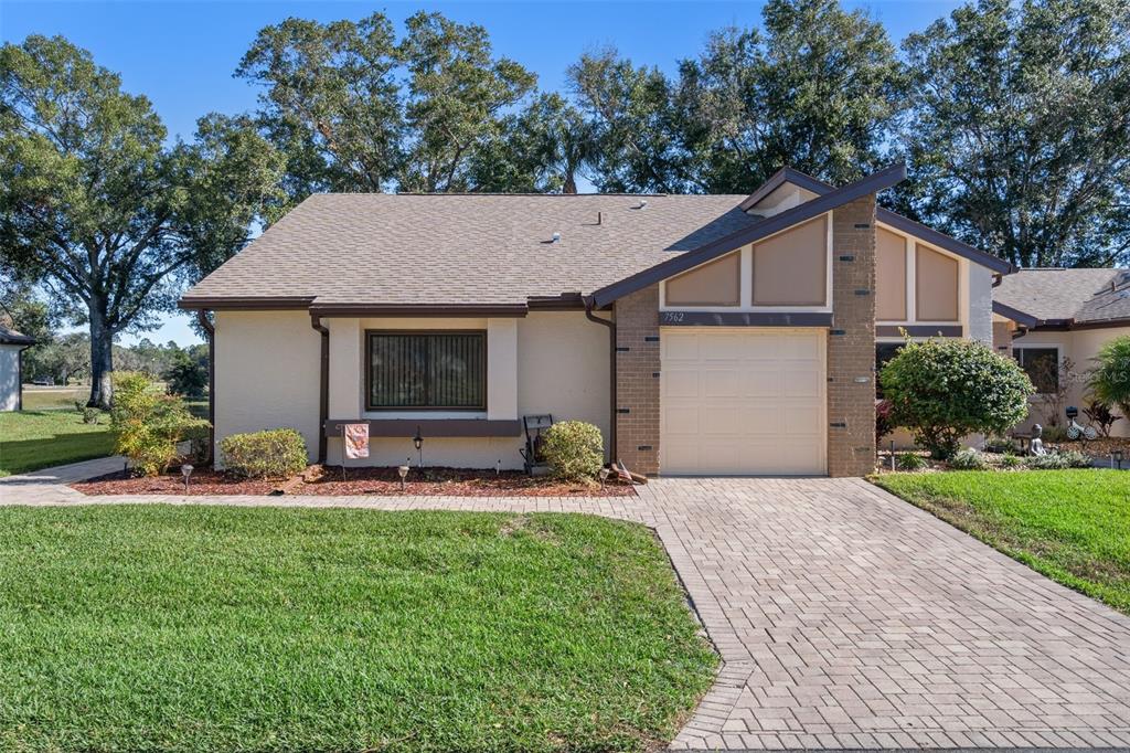 a front view of house with yard and outdoor seating