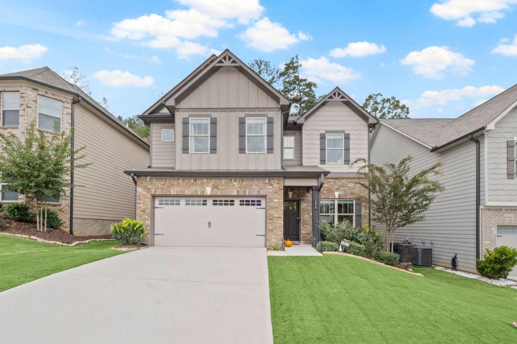 a front view of a house with a yard and garage