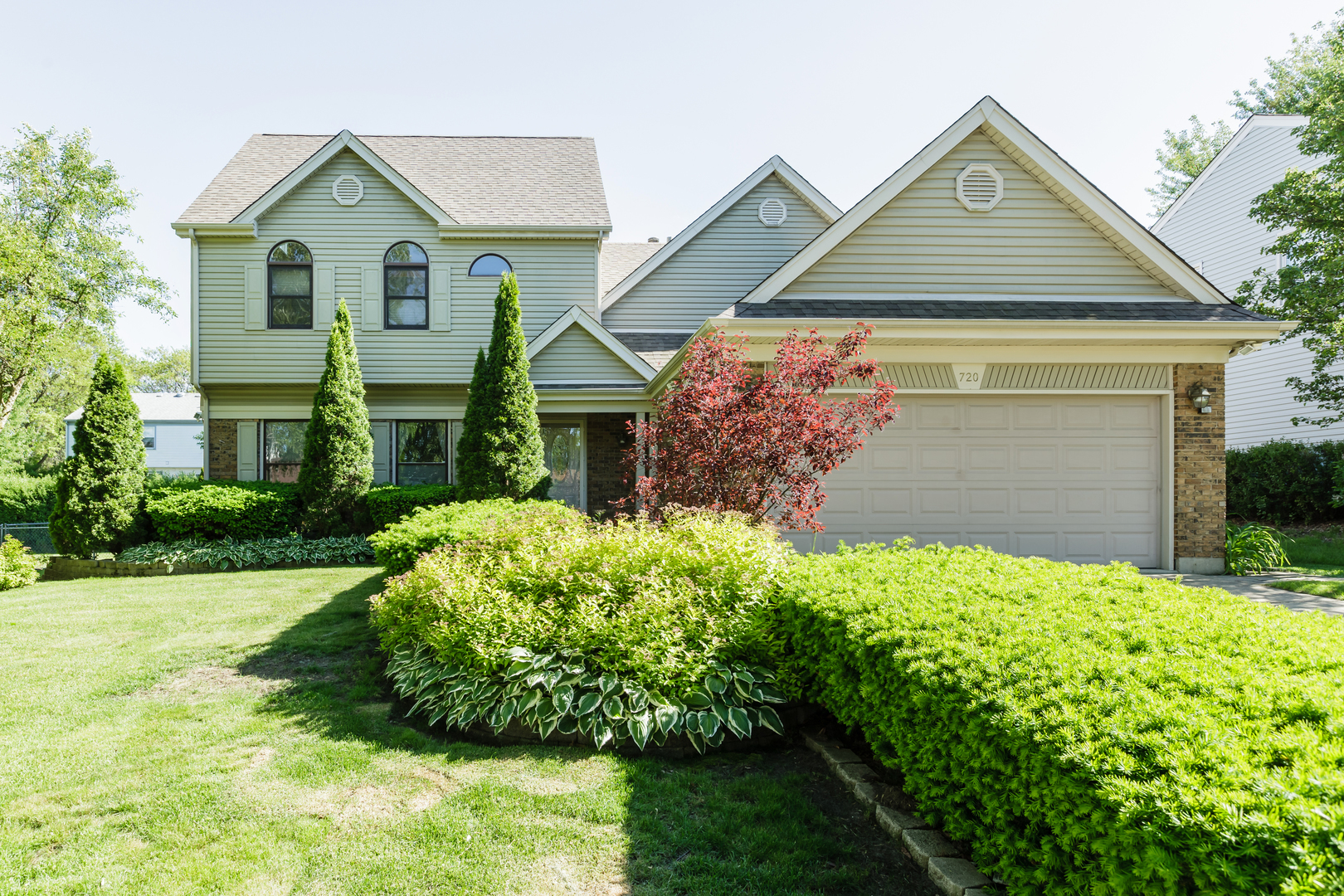 a front view of a house with a garden