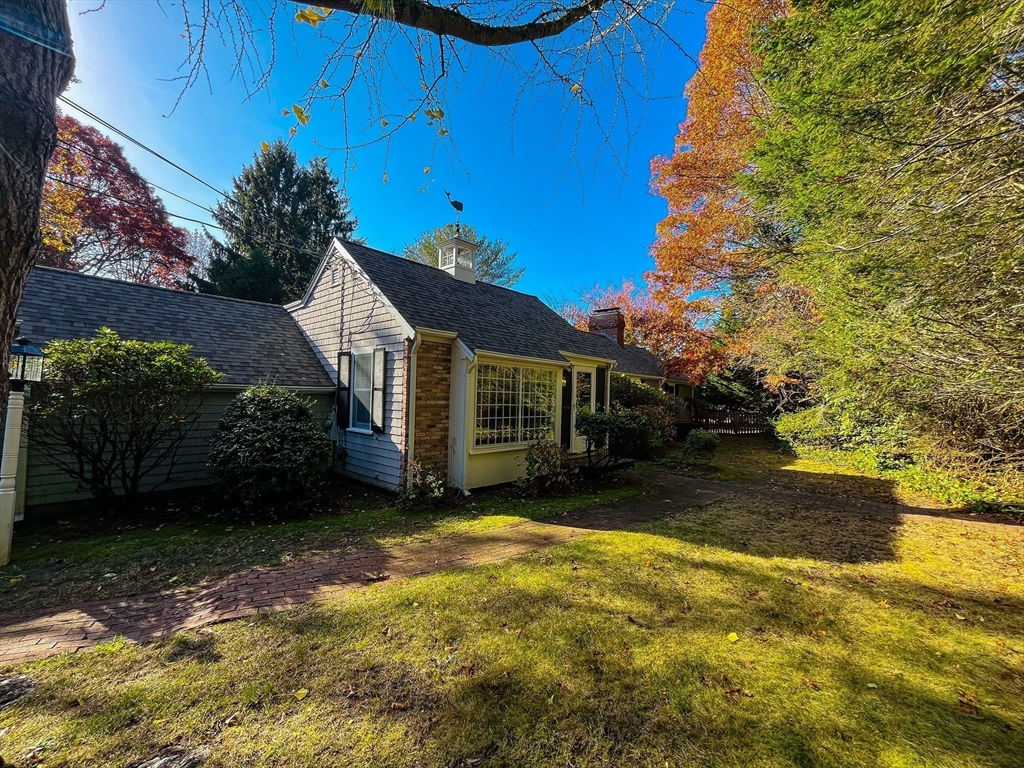 a view of a house with backyard and tree