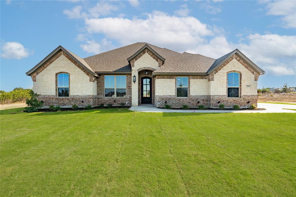 a front view of house with yard and green space