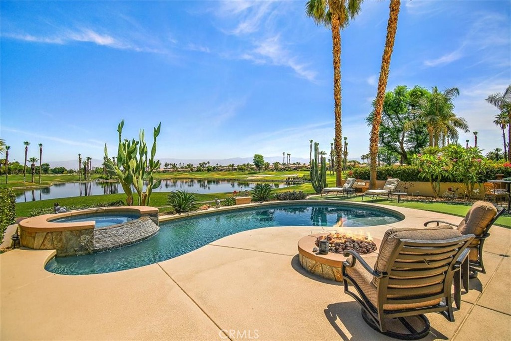 a view of swimming pool with outdoor seating and plants