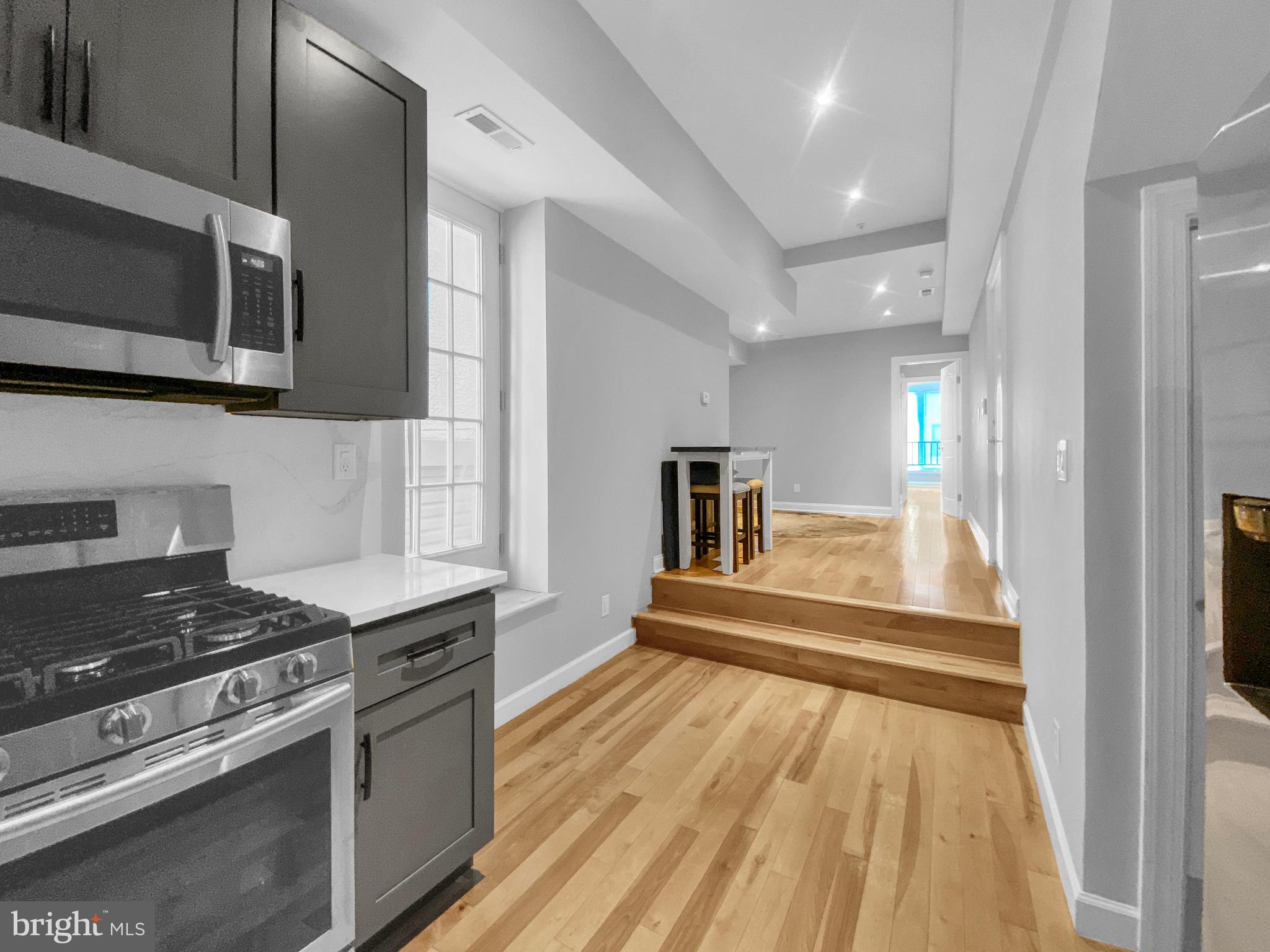 a kitchen with stainless steel appliances granite countertop a stove and a sink