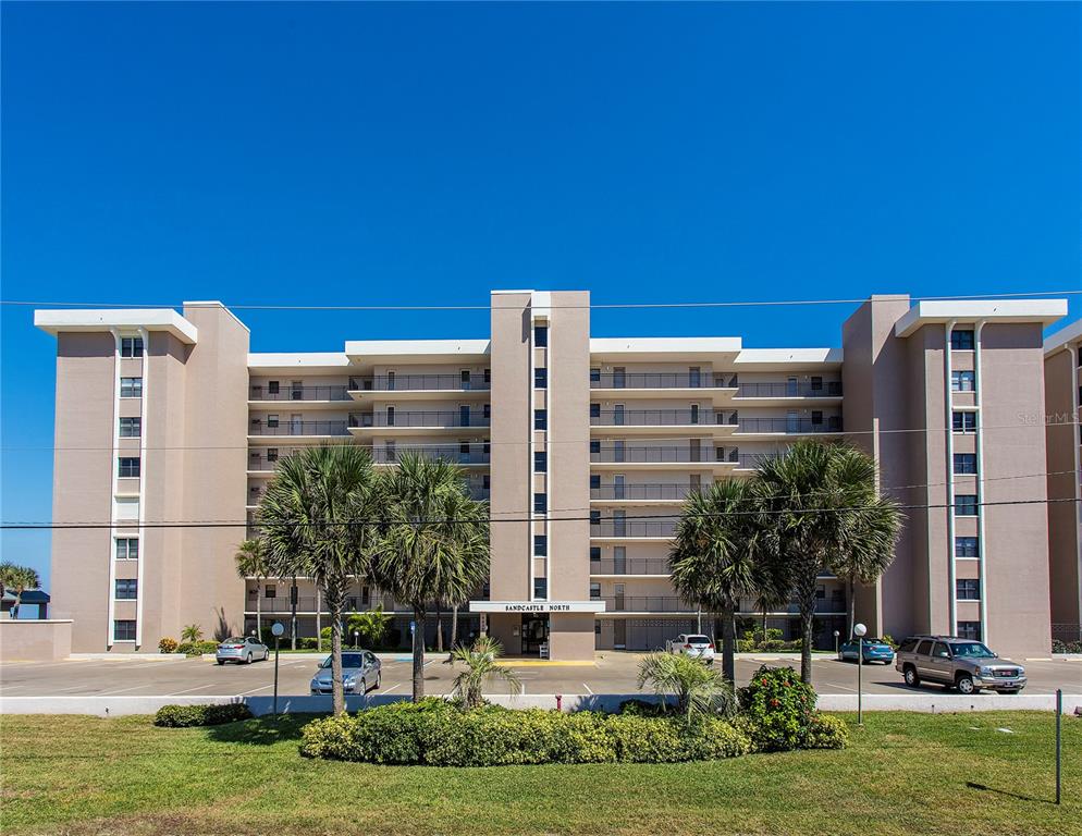 a front view of a building with a yard