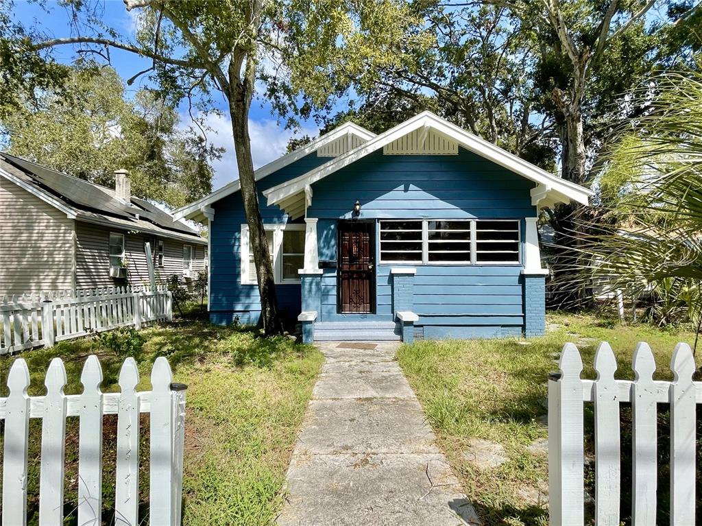 a front view of house with yard and trees around