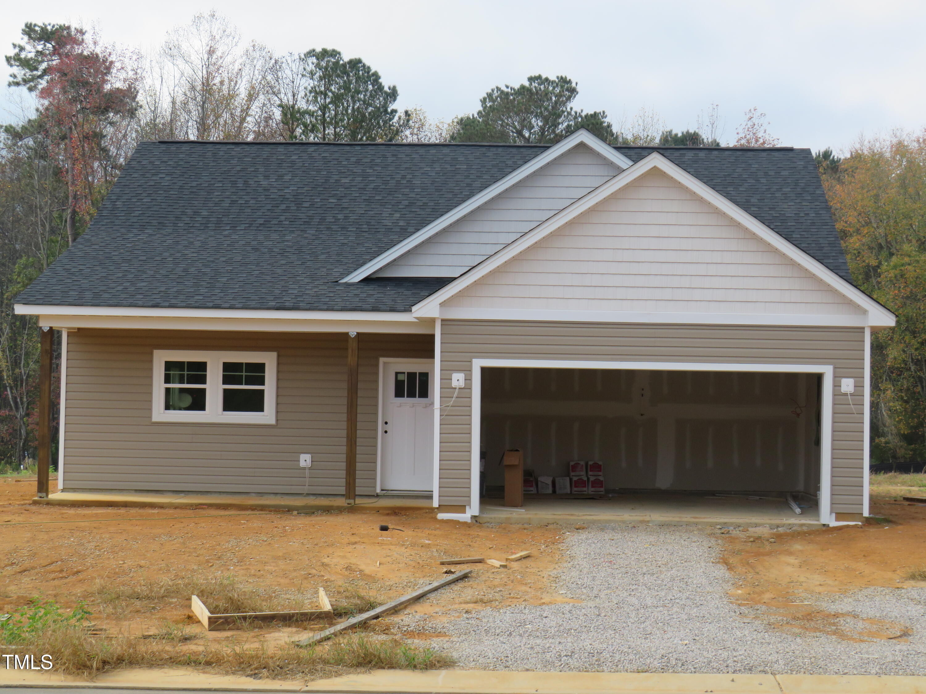 a view of house with garage and yard