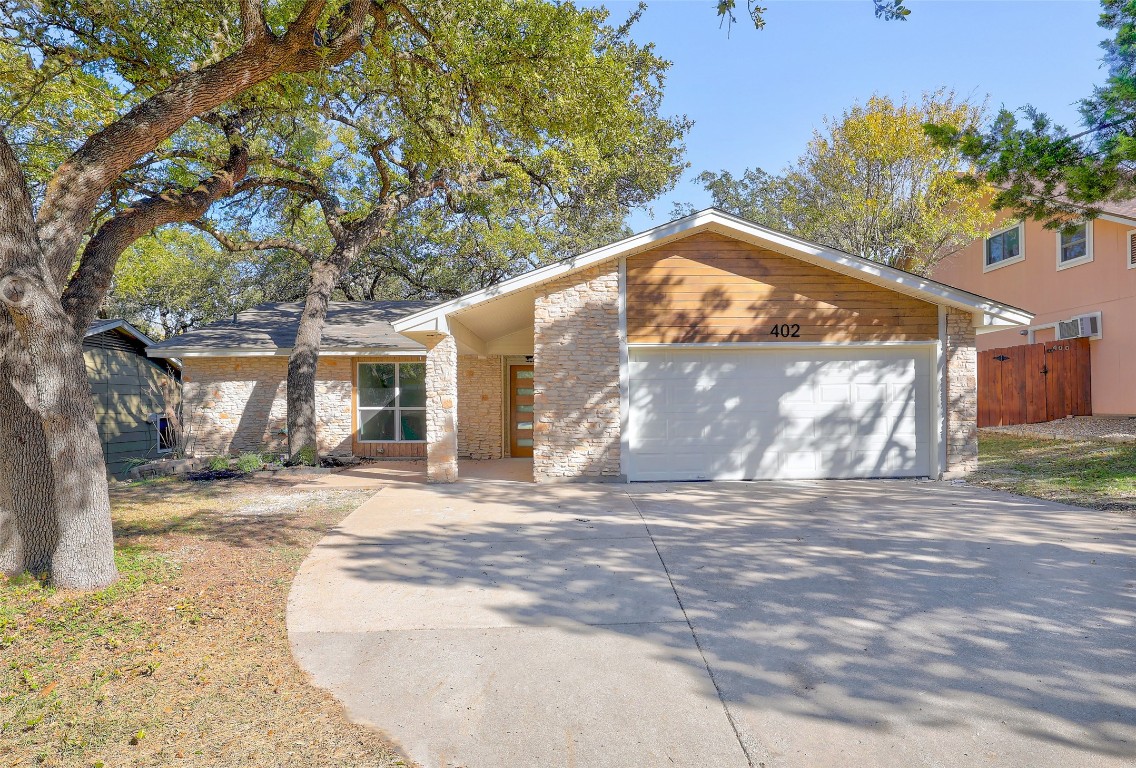 a view of a house with a yard and garage