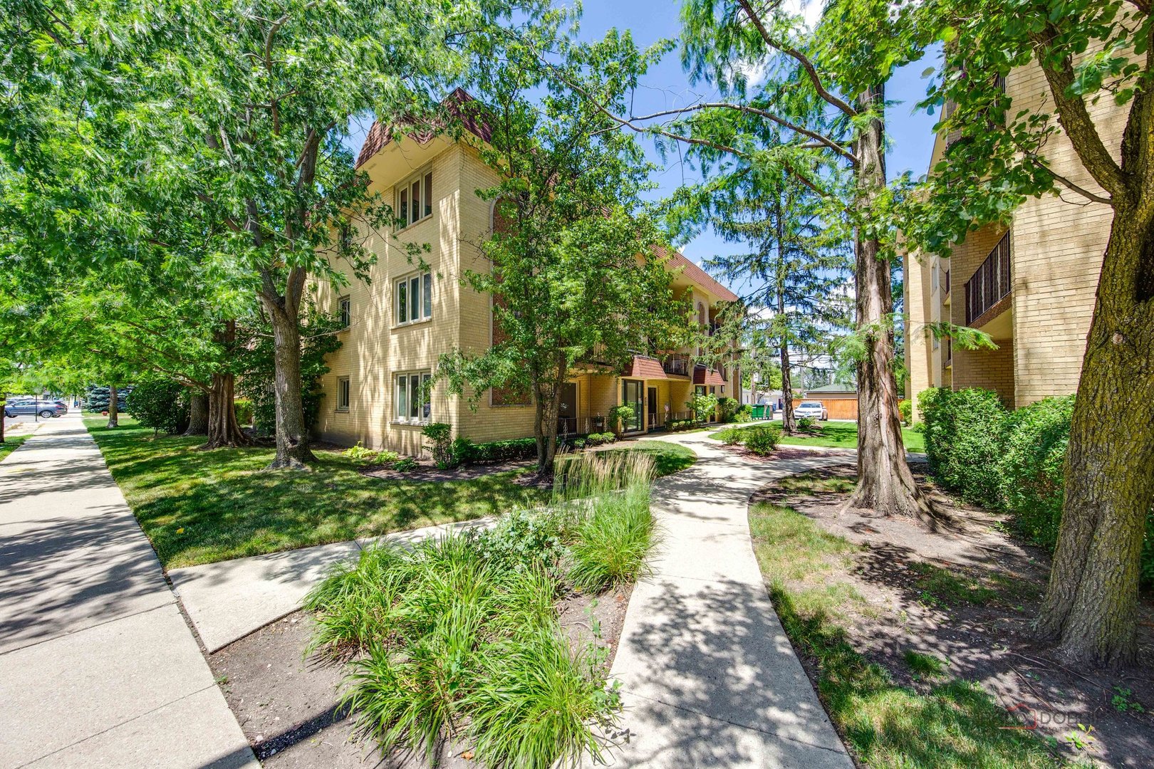 a front view of a house with a yard and fountain