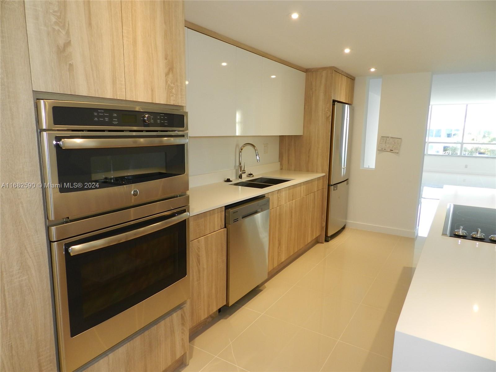 a kitchen with stainless steel appliances granite countertop a stove and a refrigerator