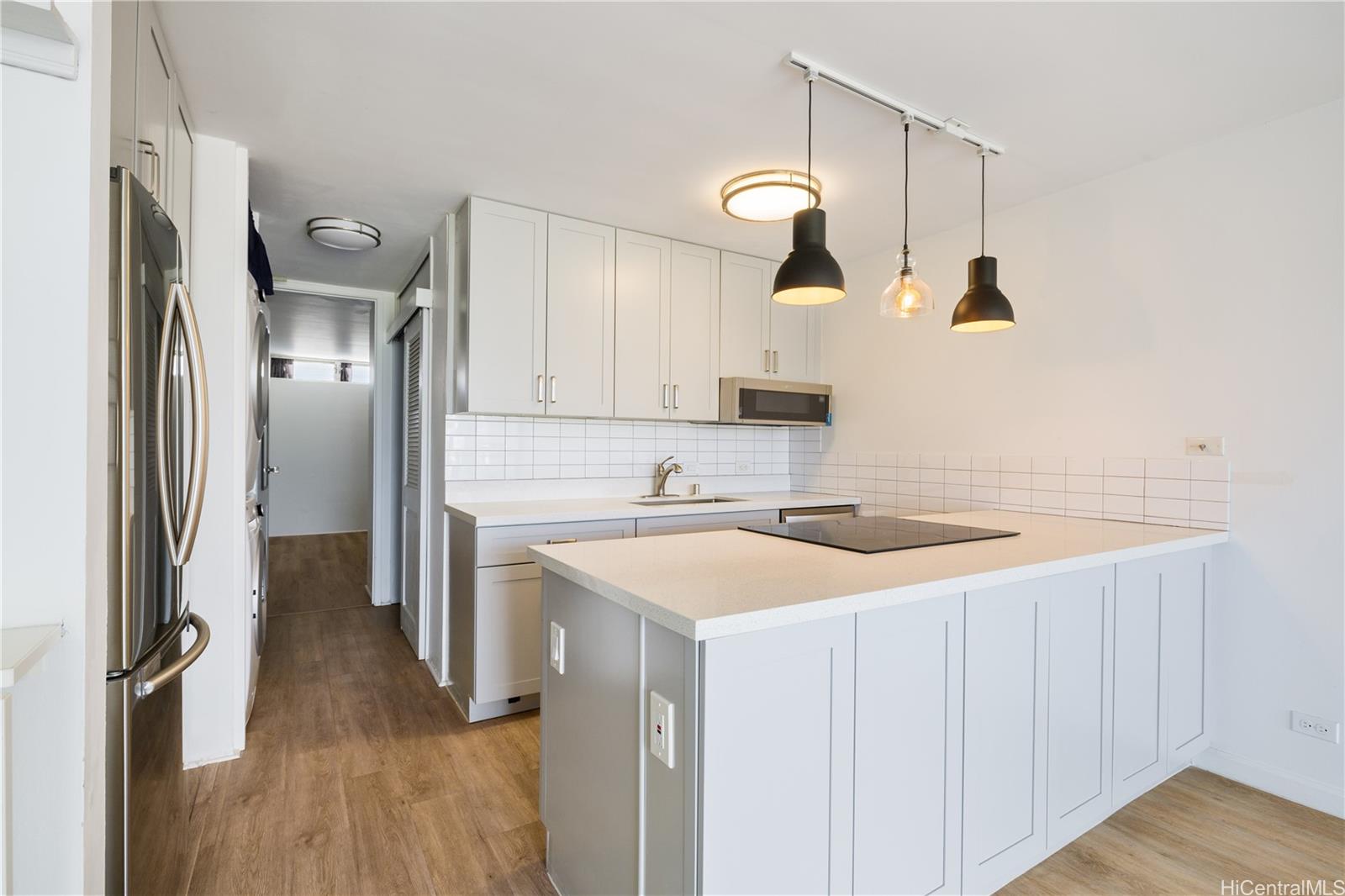 a kitchen with a sink and a refrigerator