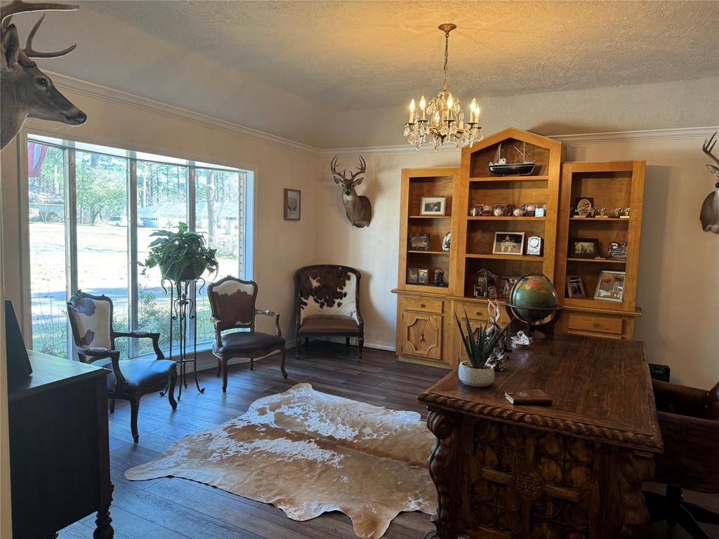 a living room with furniture a dining table and a chandelier