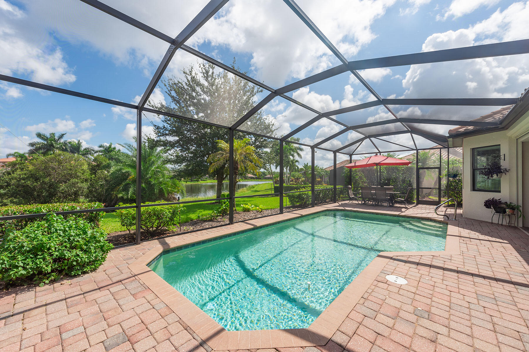 a view of a swimming pool with a patio and a yard