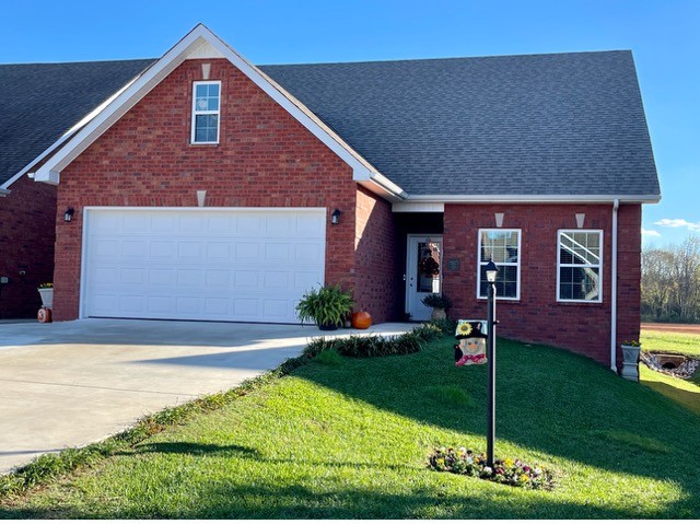 a front view of house with yard and green space