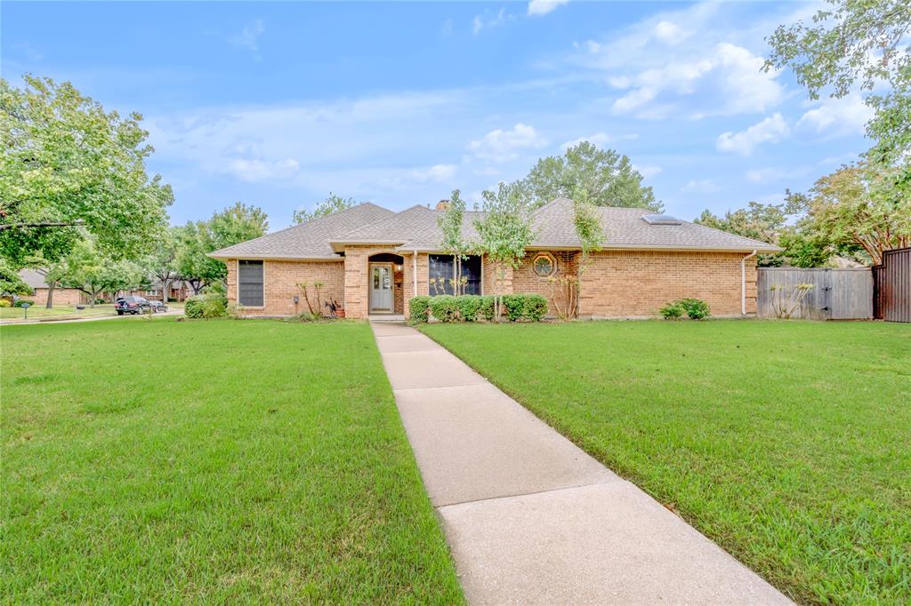 a view of house that has a yard