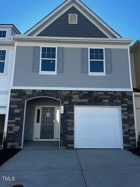 a front view of a house with garage