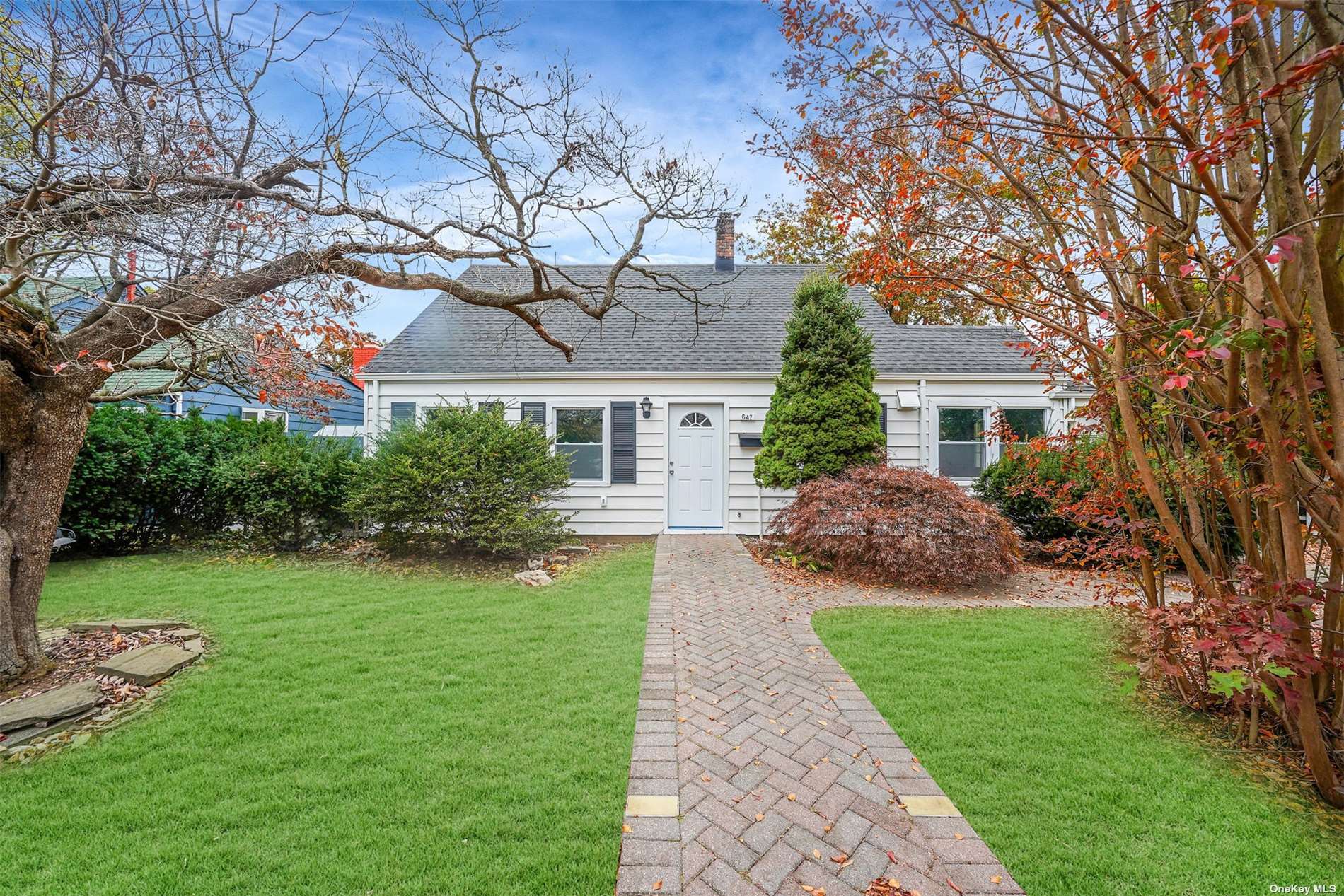 a front view of a house with a garden