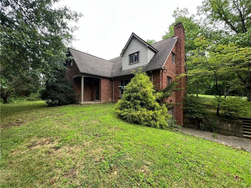 a front view of a house with a garden