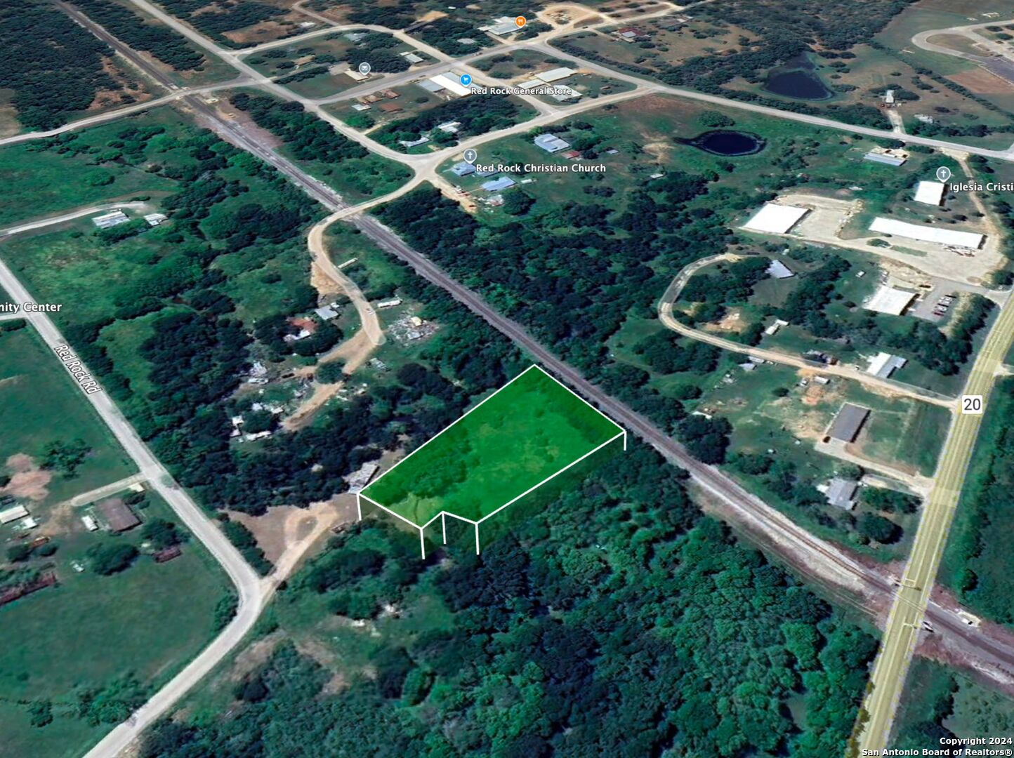 an aerial view of a residential houses with outdoor space and street view