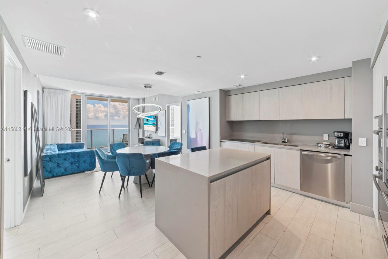 a kitchen with a sink stove and white cabinets