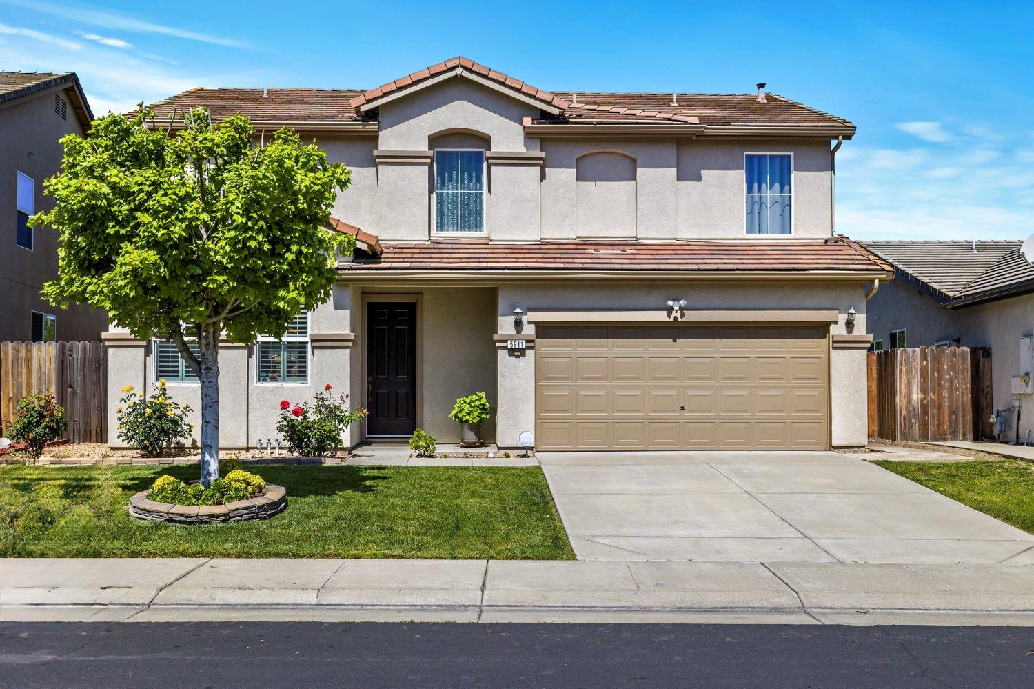 a front view of a house with a yard and garage