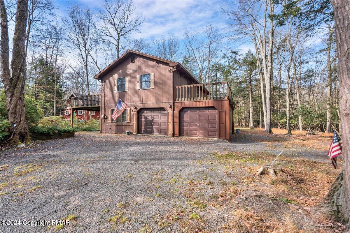 a view of a house with a yard and garage