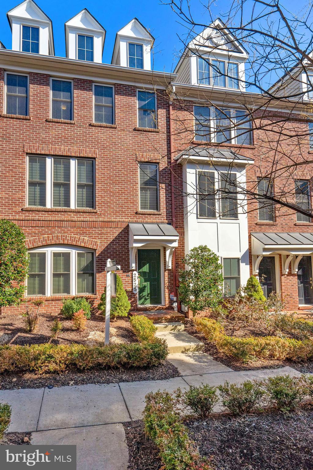 a front view of a residential apartment building with a yard