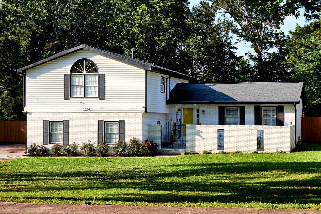 a front view of a house with a yard