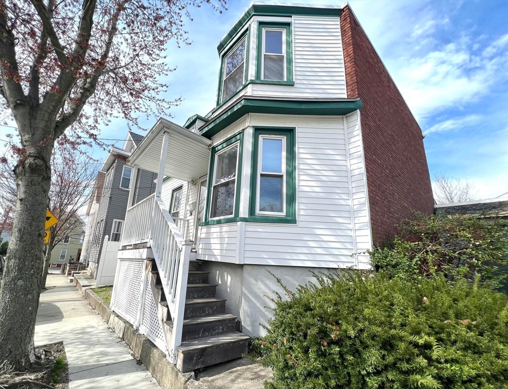 a side view of a house with a yard