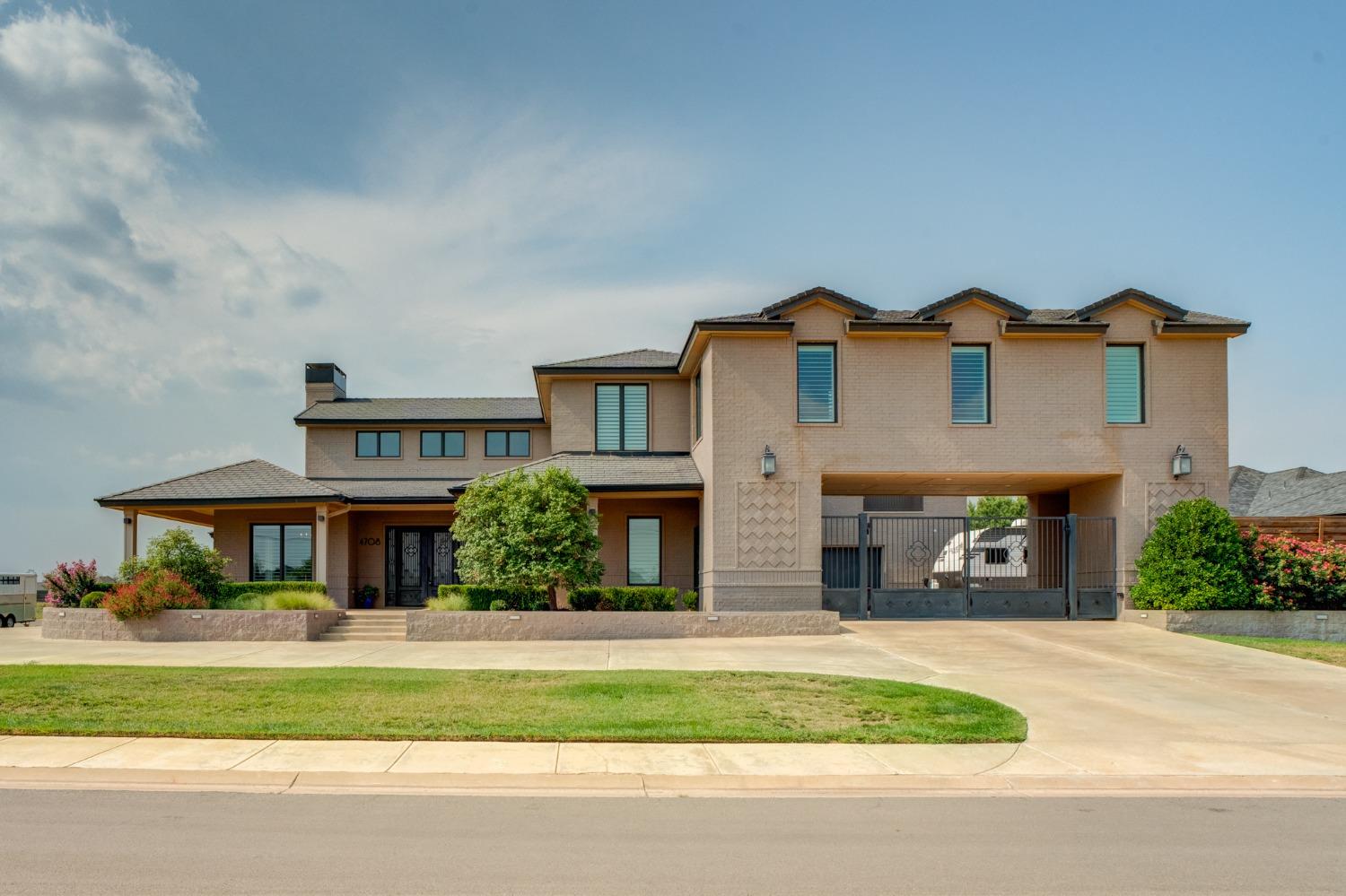 a front view of a house with a garden and garage