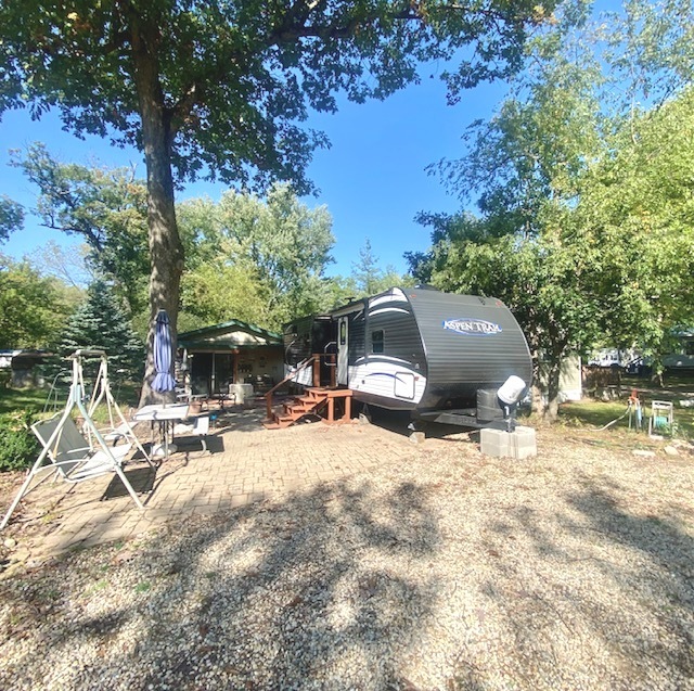 a view of backyard with a table and chairs under an umbrella