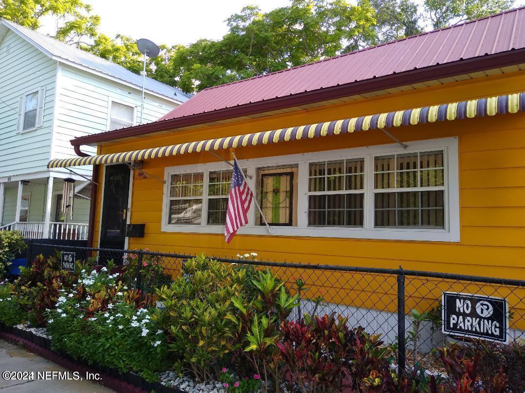 a front view of a building with flowers