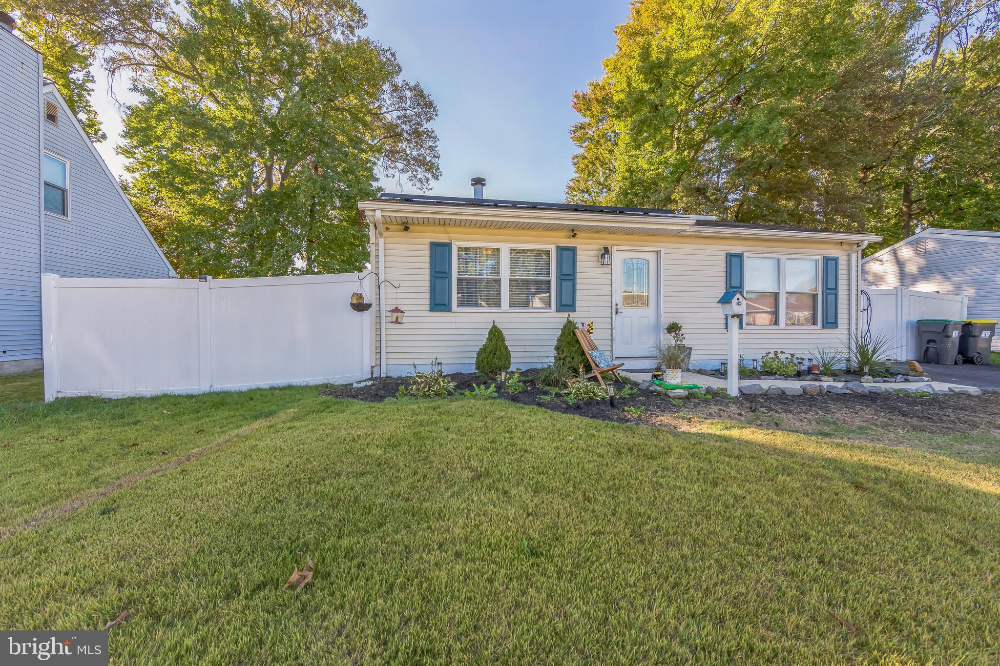 a view of a house with a backyard and a tree