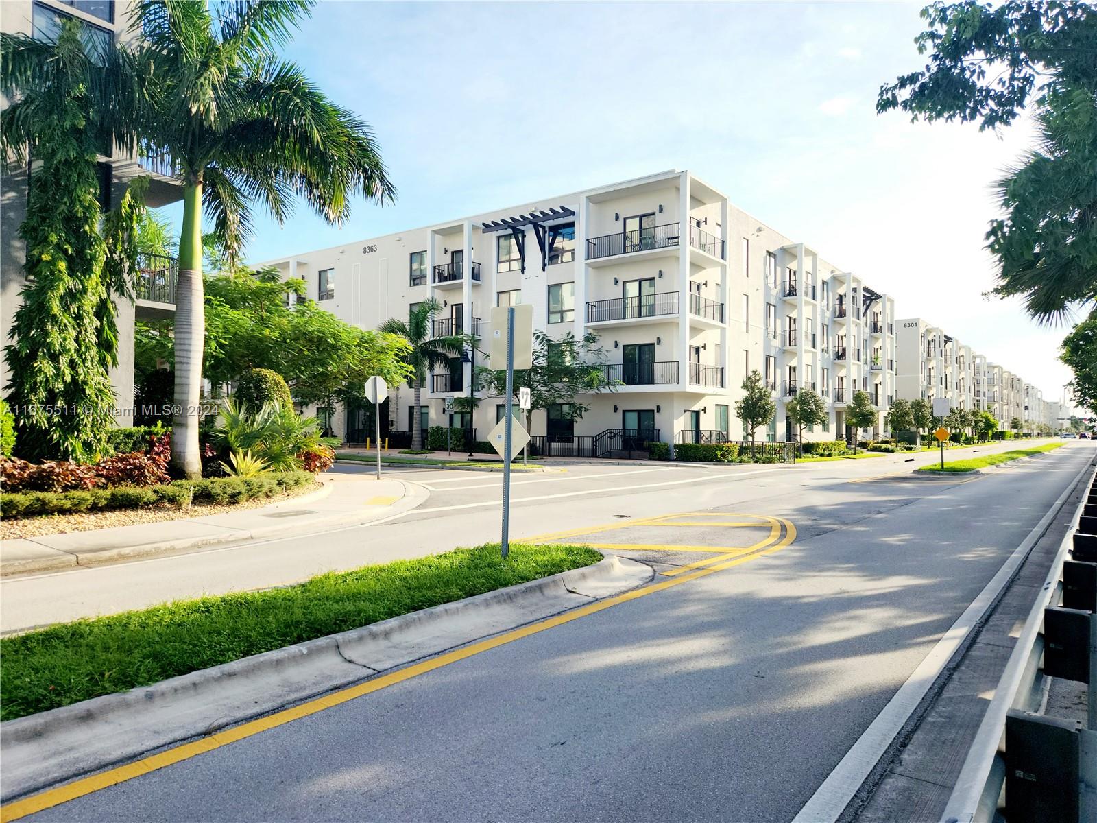 a view of street with tall buildings