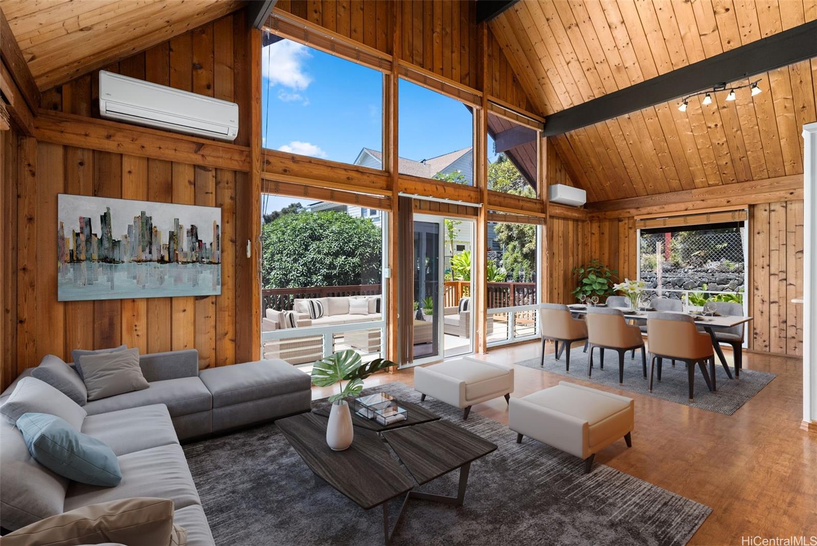 a living room with furniture a fireplace and large windows