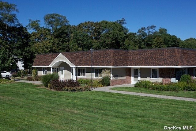 a front view of house with yard and green space