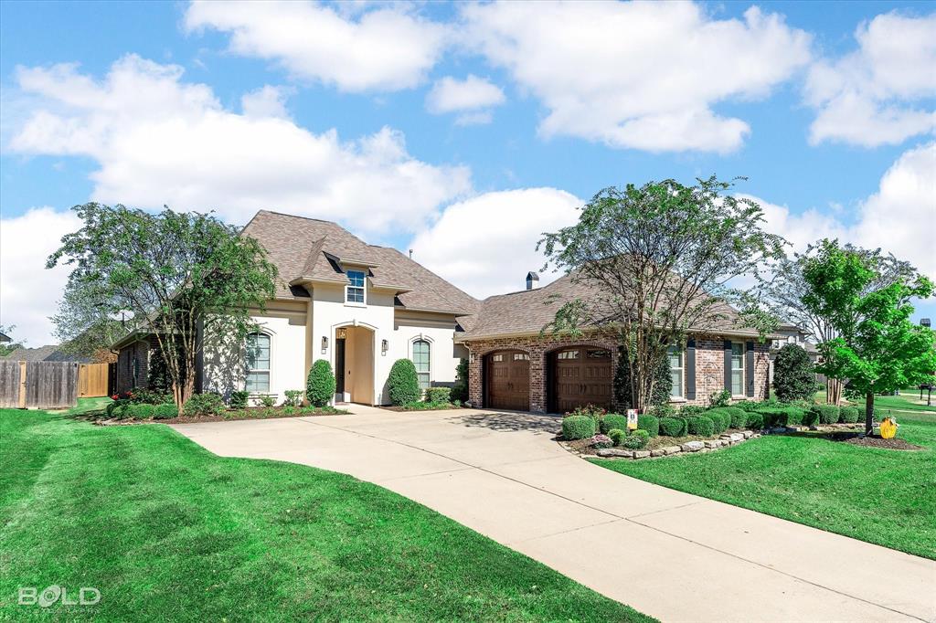 a front view of house with yard and green space