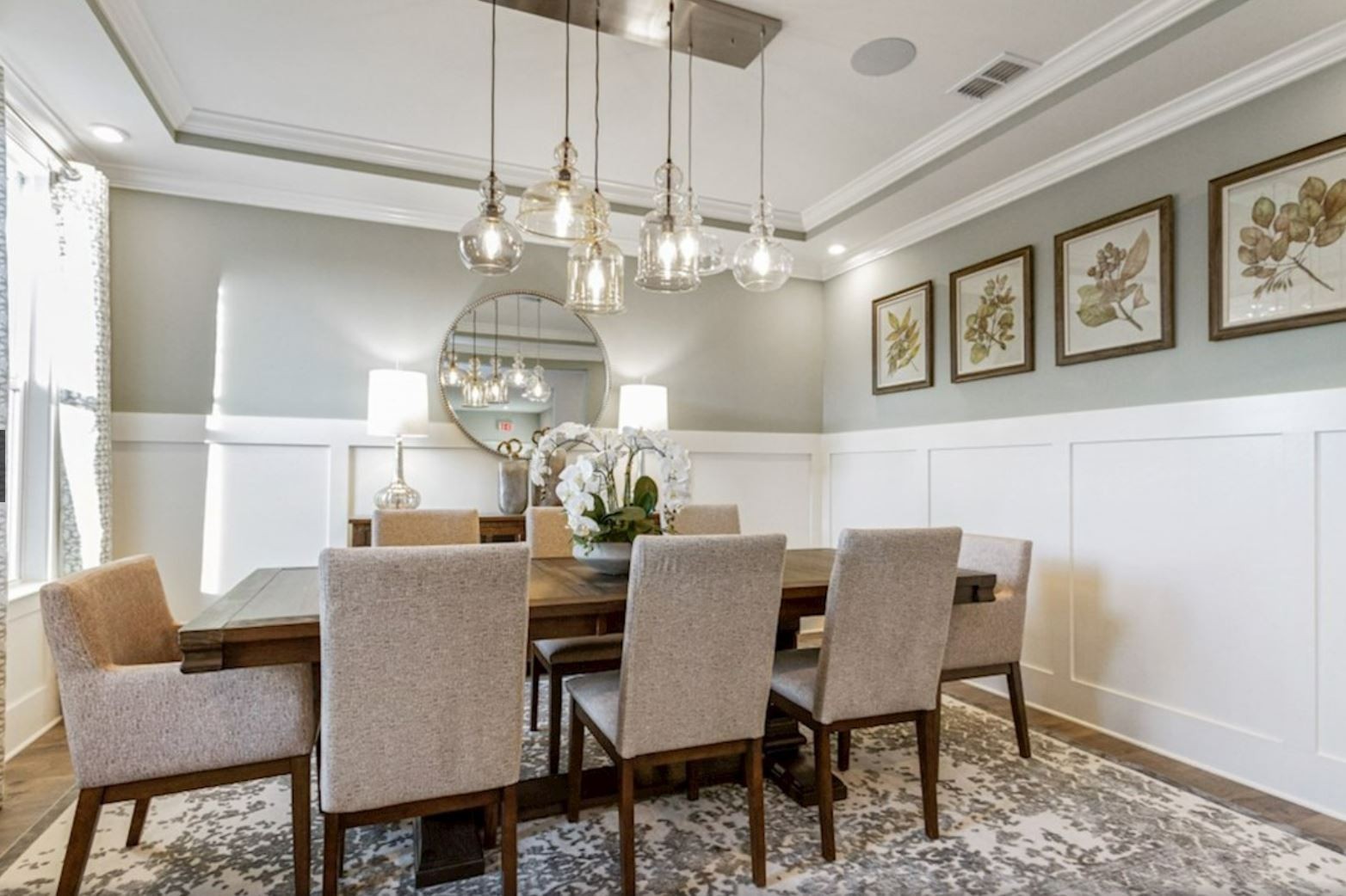 a view of a dining room with furniture a chandelier and wooden floor