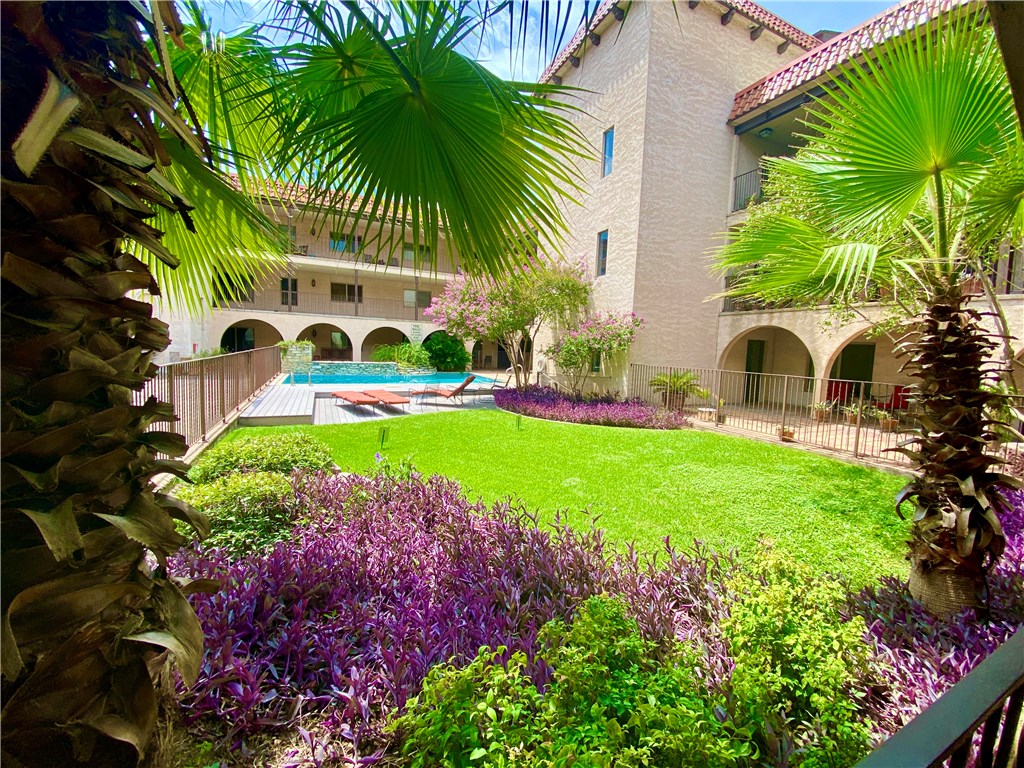 a front view of a house with a garden and plants