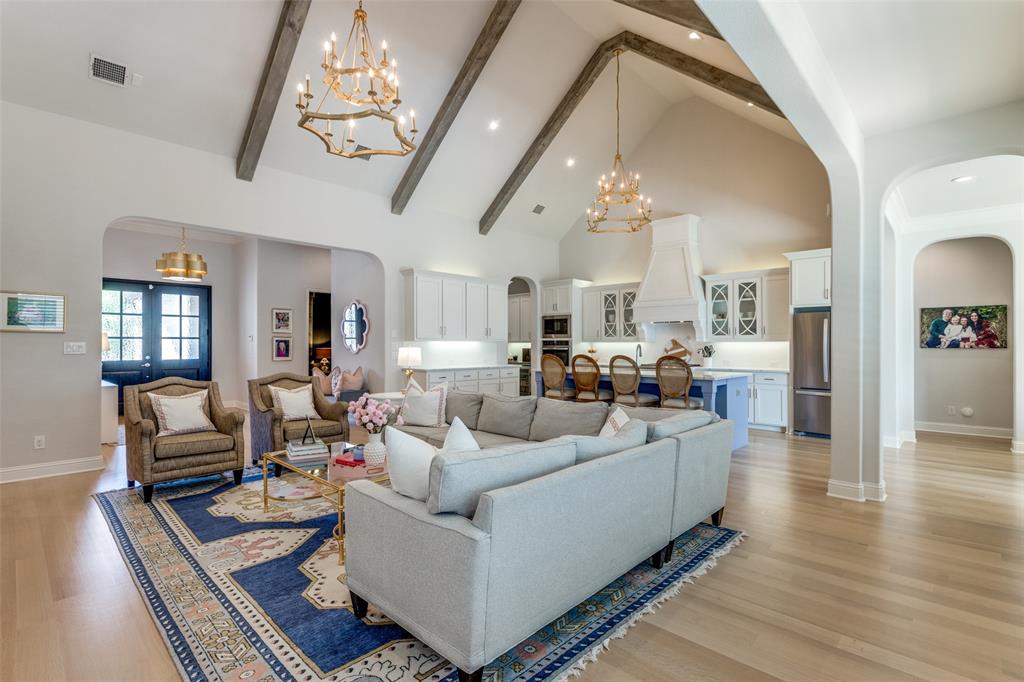 a living room with furniture and a chandelier