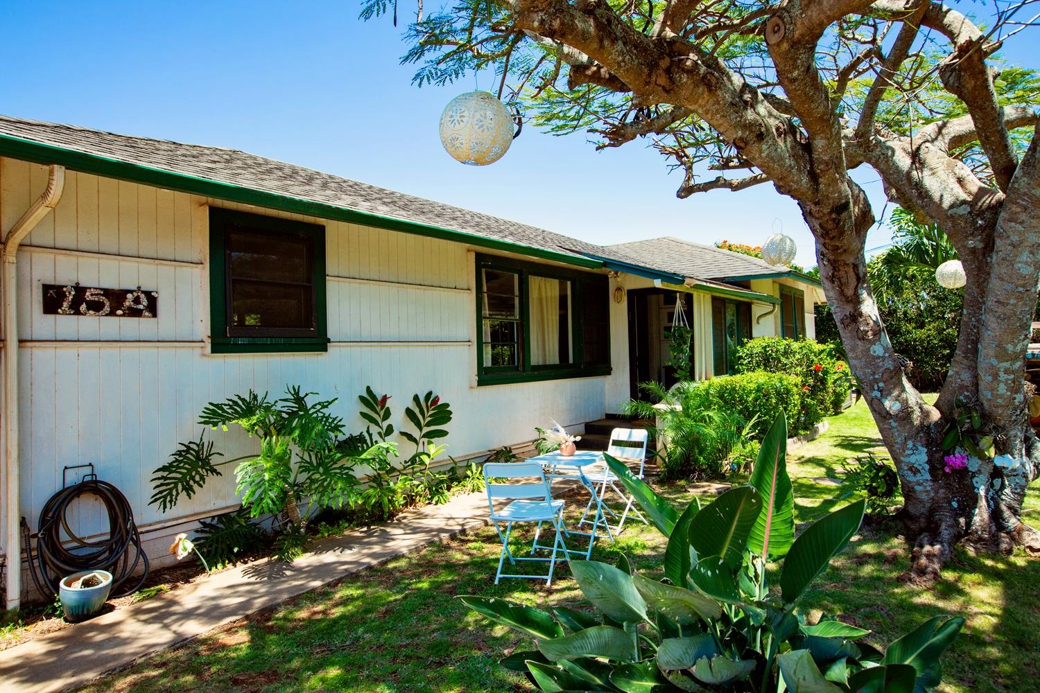 a backyard of a house with table and chairs