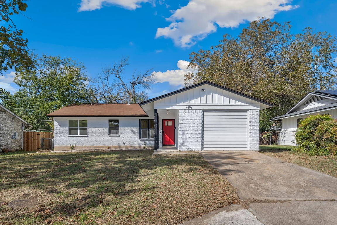 a view of a house with a yard and garage