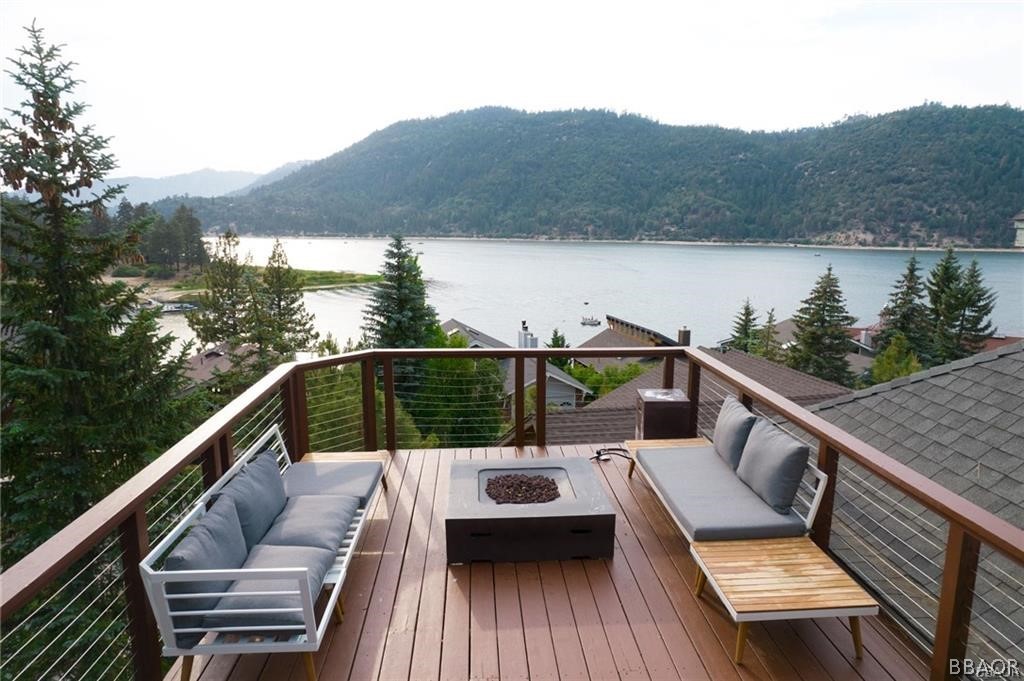 a view of a balcony with mountain view and wooden floor