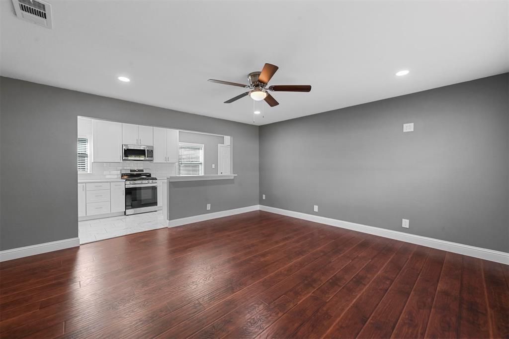 a view of a kitchen with a dishwasher and wooden floor