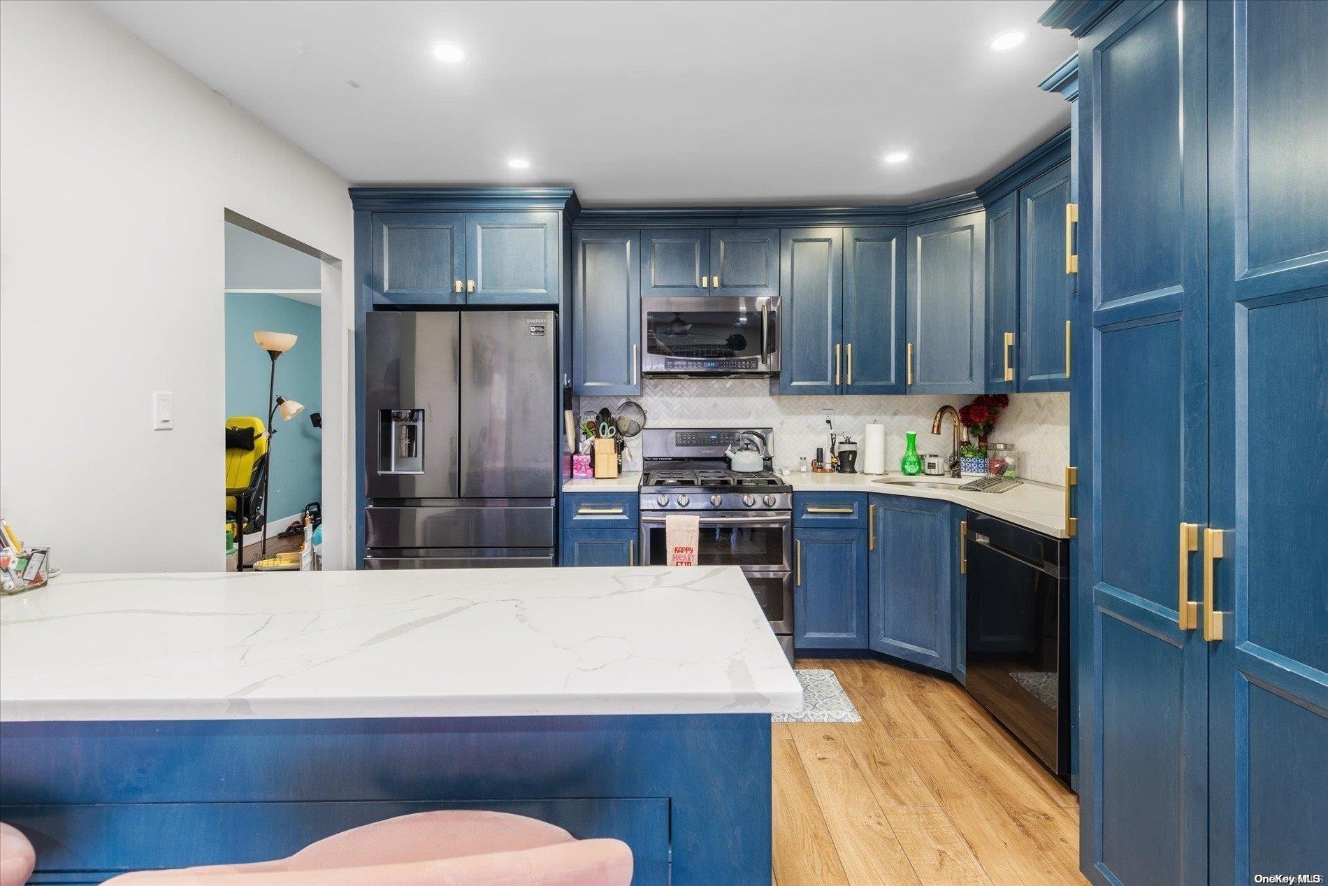 a kitchen with stainless steel appliances wooden floors and wooden cabinets