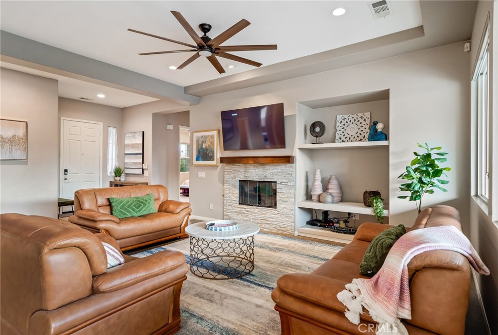 a living room with furniture and a fireplace