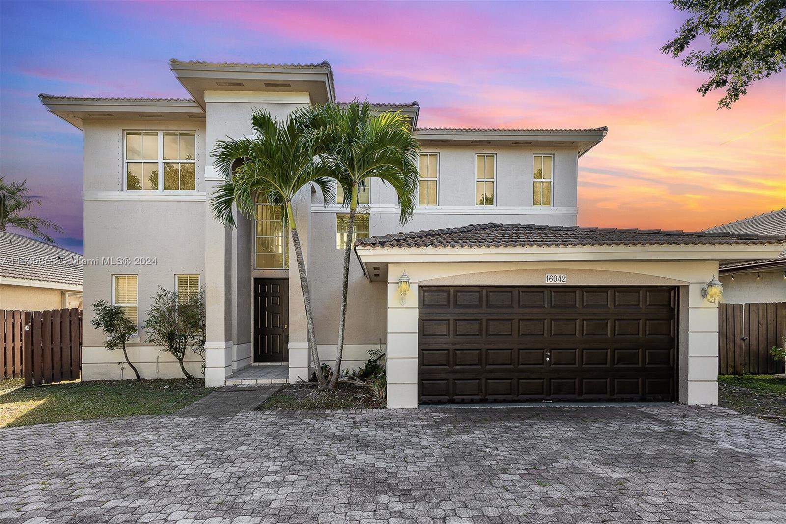 a front view of a house with garage