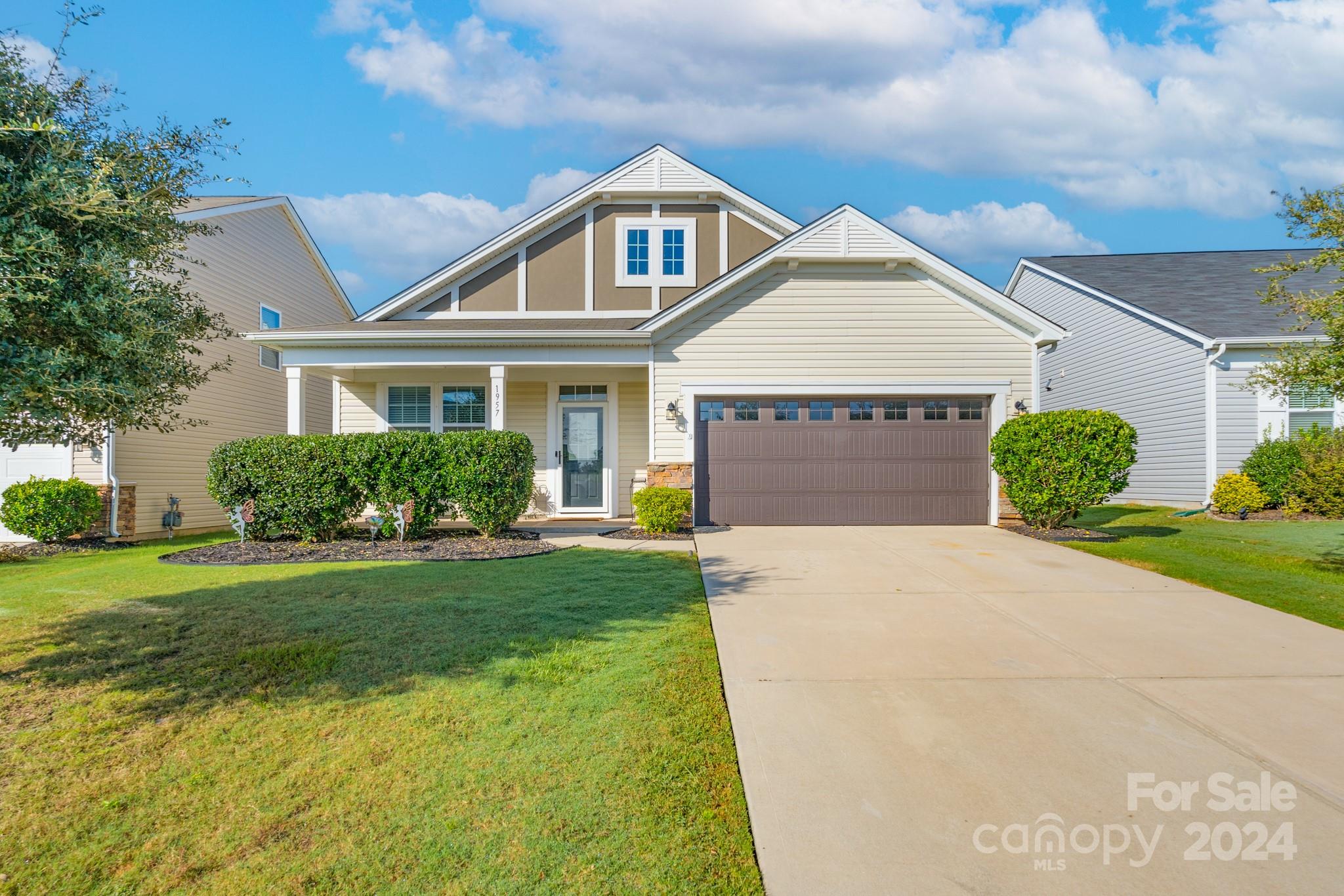 a front view of a house with a yard and garage