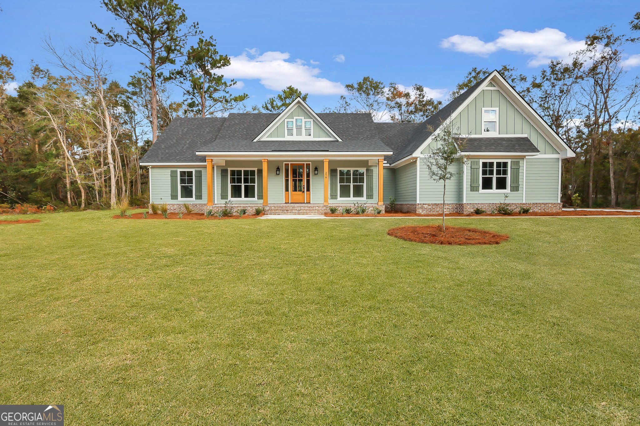 a front view of a house with a garden