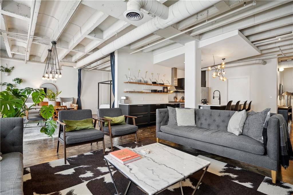 a living room with furniture and a chandelier