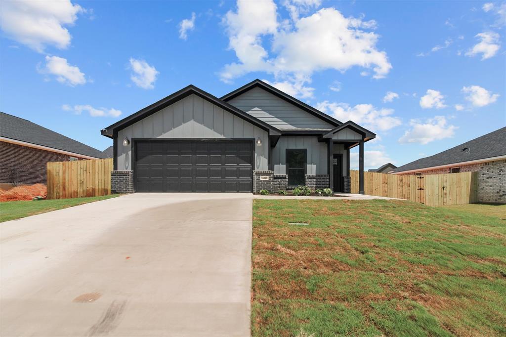 a front view of a house with yard and garage